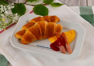 a plate of food with croissants and fruit on a table at HOTEL&SPA SIESTA ( Adult Only) in Shijonawate +64 photos