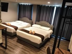 Postel nebo postele na pokoji v ubytování Pimpimarn Hotel