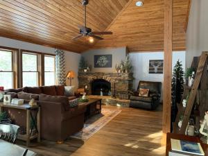 a living room with a couch and a fireplace at Myers Chalet in Ellicottville