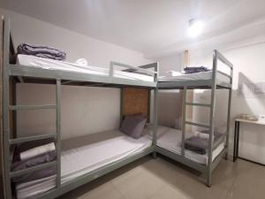 a room with three bunk beds in a room at Studio 41 Salaya-Sai4 in Nakhon Pathom