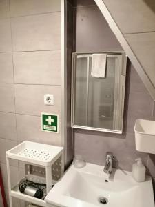 a bathroom with a sink and a mirror at Sao filipe Studio by Casas de Setúbal in Setúbal
