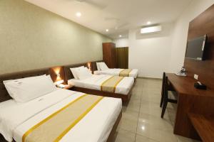 Postel nebo postele na pokoji v ubytování Hotel Laxmi Cityside