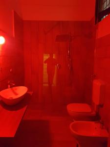 レッチェにあるDimora San Leucioの赤いバスルーム(トイレ2つ、シャワー付)