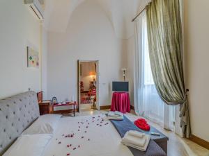 a bedroom with a bed with red flowers on it at Dimora San Leucio in Lecce