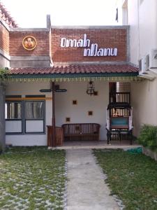 a building with a sign on the side of it at Omah Ndanu Homestay in Yogyakarta