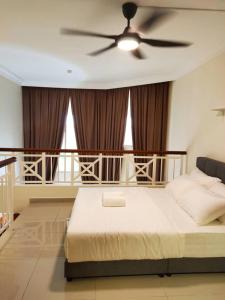 a bedroom with a bed with a ceiling fan at Lotus Desaru G510 by JSS in Bandar Penawar
