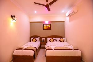 A bed or beds in a room at Nitheesh Residency