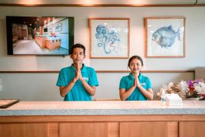 a man and a woman standing at a counter with their hands in front at One Degree Sunset Hill Leisure in Uluwatu