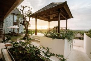 a garden with a pavilion on top of a house at One Degree Sunset Hill Leisure in Uluwatu