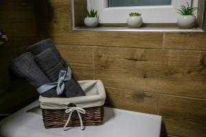 a basket of towels sitting on top of a toilet at "34" Apartment in Belgrade
