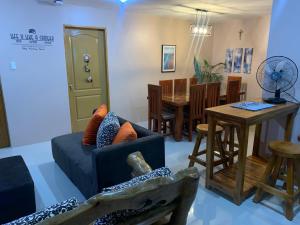 a living room with a couch and a table at Cozy Apartment near CSI Mall, San Fernando La Union in San Fernando