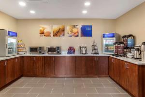 a kitchen with a counter with microwaves and appliances at Comfort Inn & Suites in Winchester