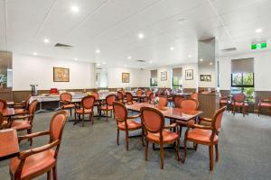 a dining room with tables and chairs in it at Comfort Hotel Dandenong in Dandenong