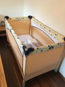 a bed with a crib with polka dots on it at Ferienwohnung Efibach 41 in Silenen