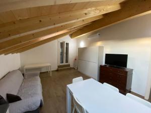 a living room with a couch and a tv at Villa Canepa in Diano Marina