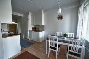 a kitchen and dining room with a table and chairs at JK Apartment Jannela in Lapua +4 photos