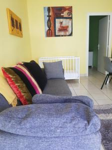 a living room with a couch and a crib at La Case Bonheur in Sainte-Anne