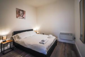 a bedroom with a large bed and a air conditioner at Private, Detached Annex with On-Street Parking in Cardiff