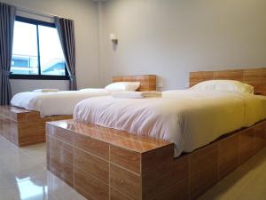 Postel nebo postele na pokoji v ubytování เดอะเบสรีสอร์ทพัทลุง