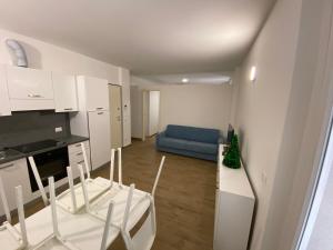 a kitchen and a living room with a blue couch at Villa Canepa in Diano Marina