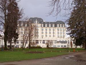 a large white building with a lot of windows at Le lavoir in Rumilly