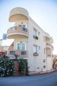 a large building with balconies on the side of it at Meandros in Almirida