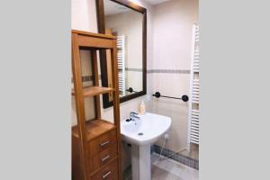 a bathroom with a sink and a mirror at Ático nuevo en el Pirineo Aragonés Panticosa in Panticosa +26 photos