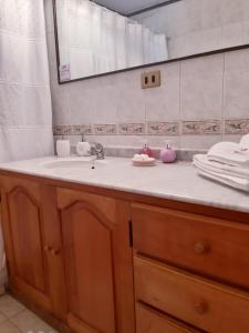 a bathroom with a sink and a mirror at Casa Emiluz in La Serena +44 photos