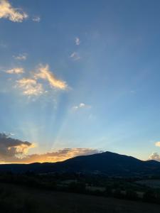 een uitzicht op de zonsondergang vanaf de top van een heuvel bij Agriturismo Spazzavento in Palazzone