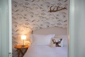een slaapkamer met een bed met een hertenkop erop bij Harbour House in Portree