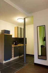 a kitchen with a pole in the middle of a room at Schickes Bielefeld Zentrum Appartement in Bielefeld