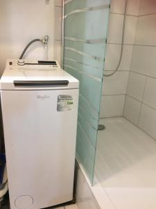 a small refrigerator in a bathroom with a shower at MaisonTevy - Appart 2 Chambres-4lits-Terrasse-Jardin & Studio-Confort-Climatisation- Idéale-Pro-Tourisme in Pontault-Combault +40 photos