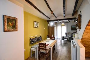 a living room with yellow walls and a table and chairs at LA CASICA in Segorbe