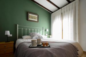 a bedroom with a bed with a tray of food on it at LA CASICA in Segorbe