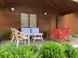 two chairs and a table on a patio at Casa Estilo Canadense - Canela in Canela