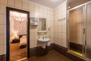 a bathroom with a sink and a shower at Kazka in Zatoka +110 photos