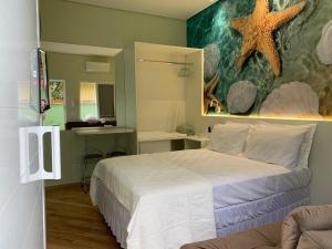 a bedroom with a bed with a starfish on the wall at Suite Starfish in Guarujá
