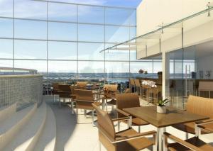 a restaurant with tables and chairs and large windows at Hotel Fusion Brasília Estacionamento Grátis G11 in Brasilia