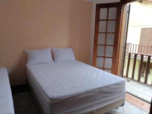 Una cama o camas en una habitación de Casa inteira no Peró, a poucos passos da praia