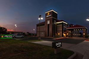 a building with an exit sign in a parking lot at La Quinta by Wyndham Midland North in Midland