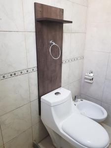 a bathroom with a white toilet and a shower at Casa Grande in Neuquén