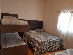 1 dormitorio con 2 literas y ventana en Casa Grande en Neuquén