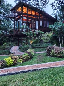 a large wooden building with a pathway in front of it at VillaHermosa B&B in San Carlos