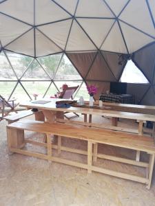 a large tent with a table and a desk at Domos Cordillera Blanca in Huaraz