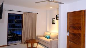 a living room with a couch and a window at Hotel Eloisa in Puerto Vallarta