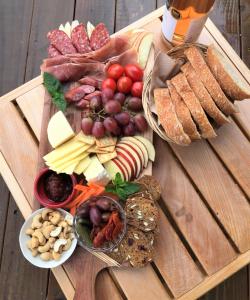 a wooden table topped with a tray of different types of food at The Hideout in Mangawhai