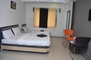 Rúm í herbergi á HOTEL SAI VISHVA KARMA