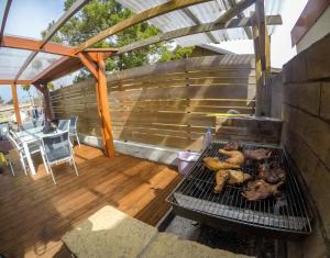 a grill with chickens on it on a patio at Case au pied du volcan in La Plaine des Cafres