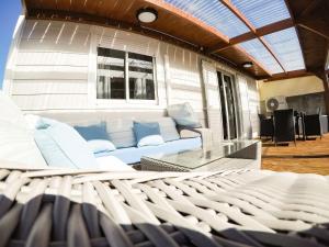 a living room with a couch and a glass table at Case au pied du volcan in La Plaine des Cafres
