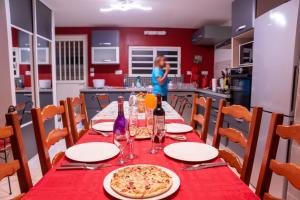 a table in a kitchen with a pizza on it at Case au pied du volcan in La Plaine des Cafres +13 photos